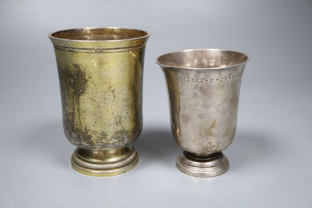 An 18th century French white metal beaker, 94mm and a later gilt white metal French beaker, 11.3cm, gross 7.5oz.